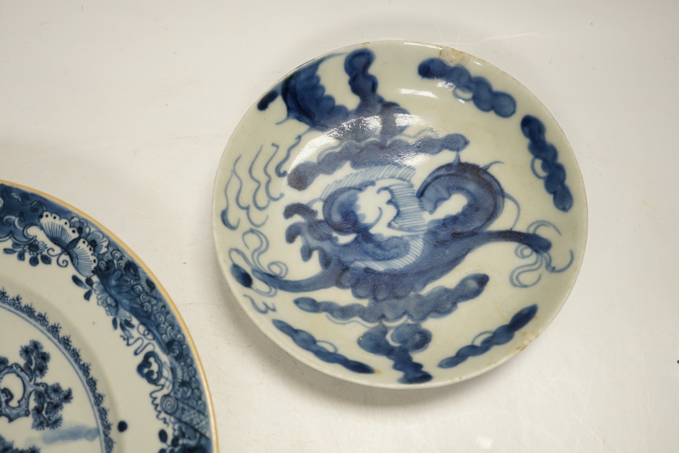 An 18th century Chinese export blue and white dish together with two others, largest 26cm